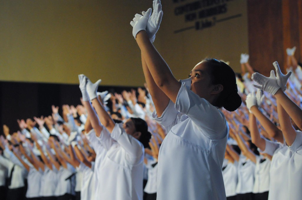 Members of the Church of God's Music Ministry render gestures of praise in an opening number during an International Thanksgiving in 2012.