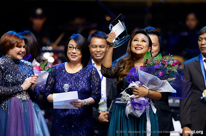 Leah Patricio raises her award in gratitude to the One above. She was hailed as the Best Interpreter of ASOP Year 4's Grand Finals. (Photo courtesy of Photoville International)